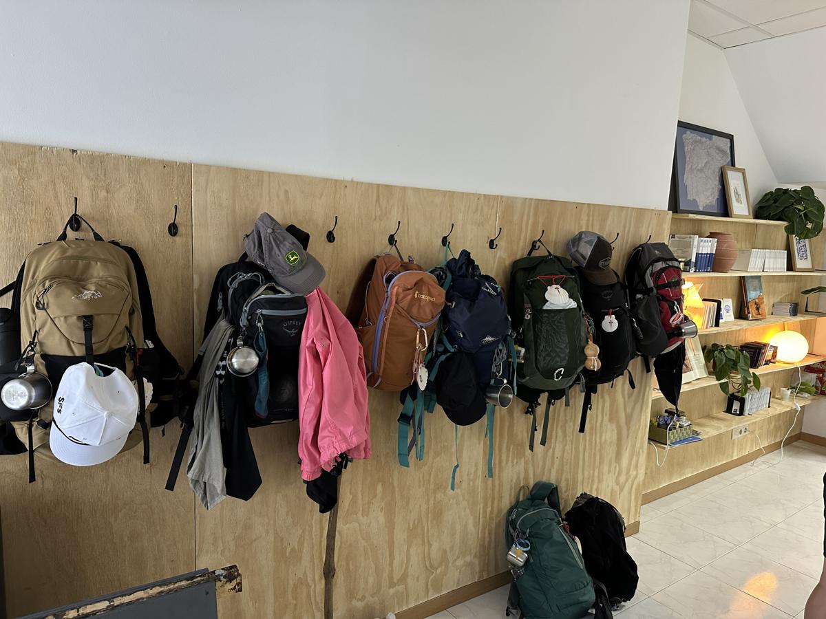 Pilgrim Center with backpacks on wall